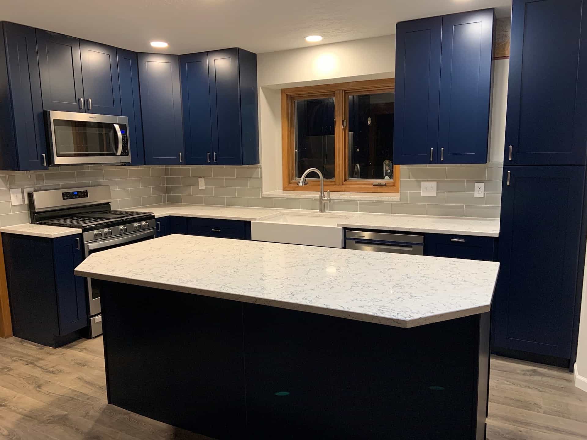 Navy cabinetry with a full-width quartz island